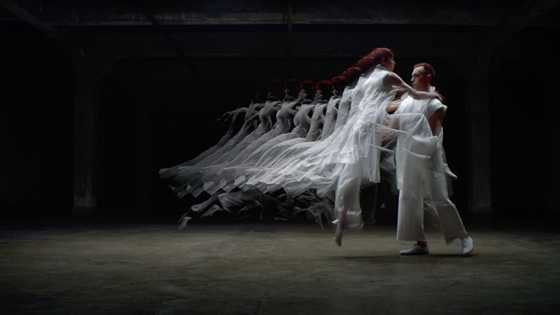 a woman jumps into a man’s arms, and several translucent frames of her image behind her